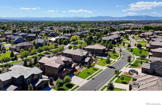 drone / aerial view featuring a residential view and a mountain view