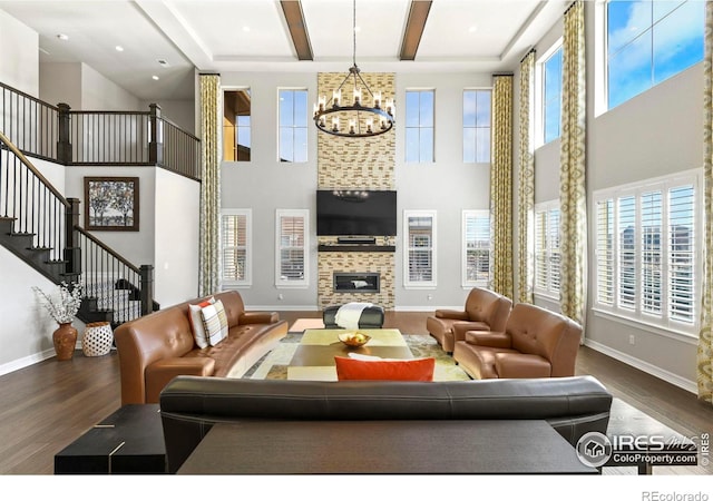 1440 Eversole Dr, Broomfield, CO 80023 - living area featuring a notable chandelier, wood finished floors, and a healthy amount of sunlight