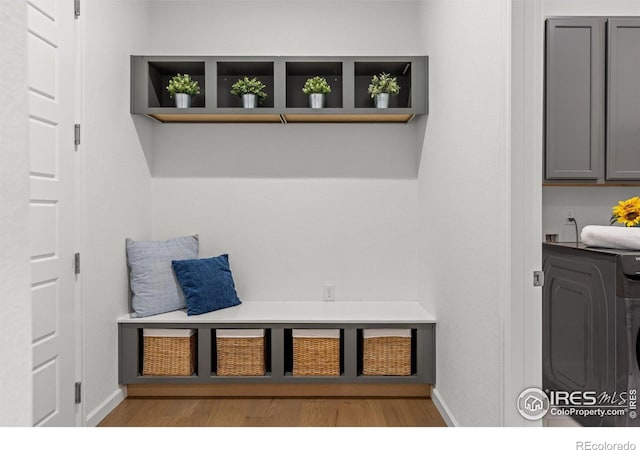 mudroom featuring baseboards, washer / dryer, and wood finished floors