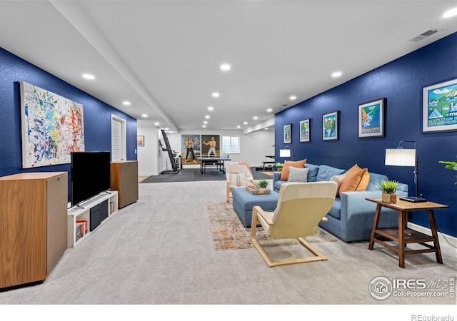 living area with recessed lighting, visible vents, and carpet