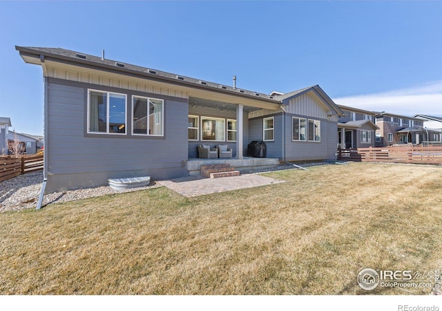 back of house featuring a patio, a yard, and fence