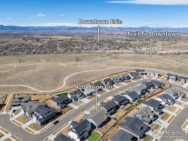 birds eye view of property with a mountain view and a residential view