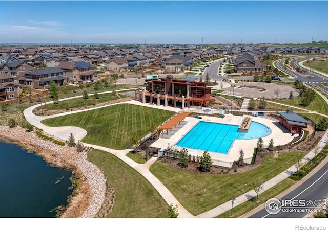 drone / aerial view with a residential view and a water view