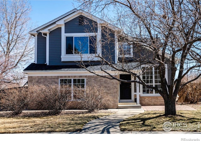 traditional-style home featuring brick siding