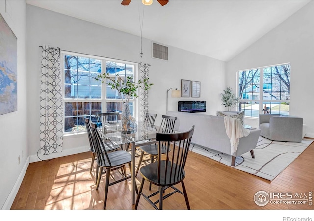 dining area with ceiling fan, visible vents, plenty of natural light, and wood finished floors