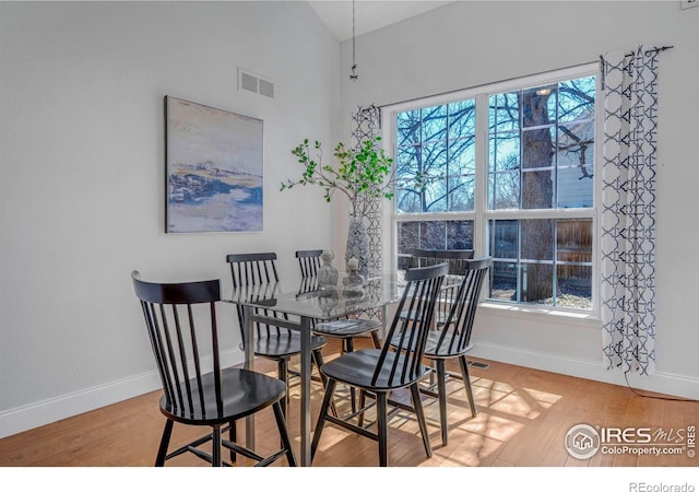 dining space featuring light wood finished floors, visible vents, plenty of natural light, and baseboards