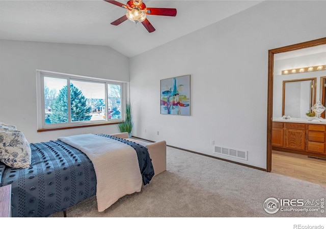 bedroom with visible vents, connected bathroom, lofted ceiling, light carpet, and baseboard heating