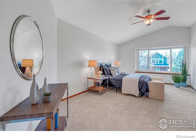 carpeted bedroom featuring lofted ceiling, baseboards, and ceiling fan