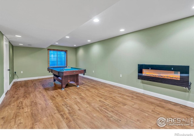 playroom featuring a glass covered fireplace, baseboards, wood finished floors, and pool table