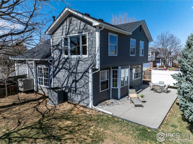 back of property with a patio area, central AC, and fence