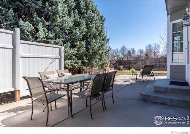 view of patio featuring outdoor dining area and a fenced backyard