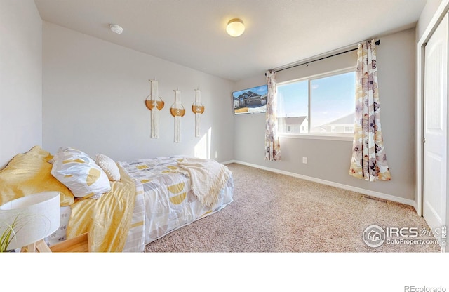 carpeted bedroom featuring visible vents and baseboards