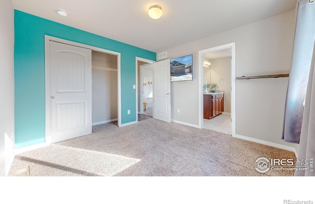 unfurnished bedroom with a closet, visible vents, baseboards, and carpet