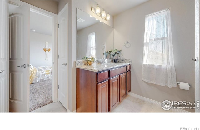 bathroom featuring tile patterned floors, connected bathroom, vanity, and baseboards