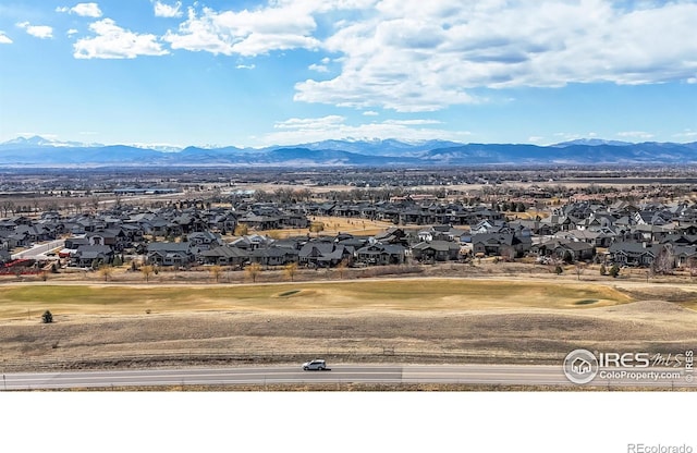 view of mountain feature with a residential view and view of golf course