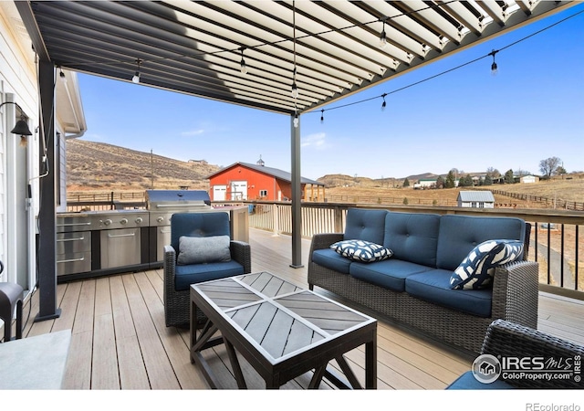 4528 Del Colina Way, Laporte, CO 80535 - deck with outdoor lounge area, grilling area, and a mountain view