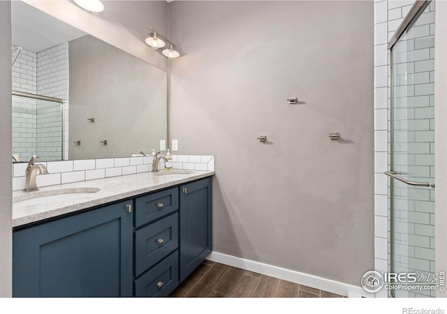 4528 Del Colina Way, Laporte, CO 80535 - full bathroom with wood tiled floors, baseboards, double vanity, and tiled shower