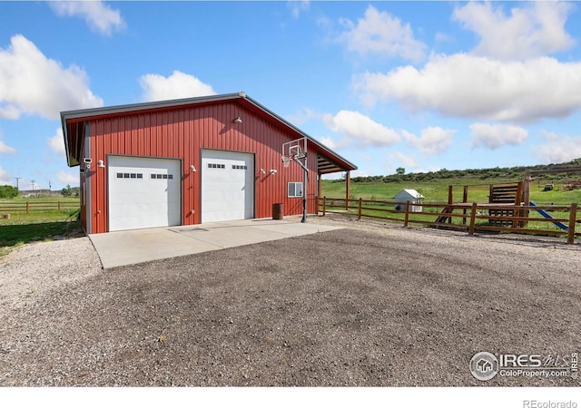 4528 Del Colina Way, Laporte, CO 80535 - detached garage featuring driveway and a view of countryside