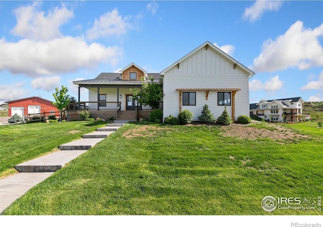 4528 Del Colina Way, Laporte, CO 80535 - view of front of home with board and batten siding, a front yard, and covered porch