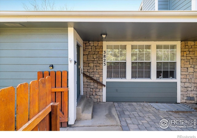 entrance to property with stone siding