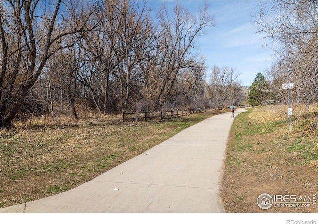 surrounding community featuring concrete driveway