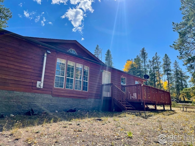 view of side of property with a deck