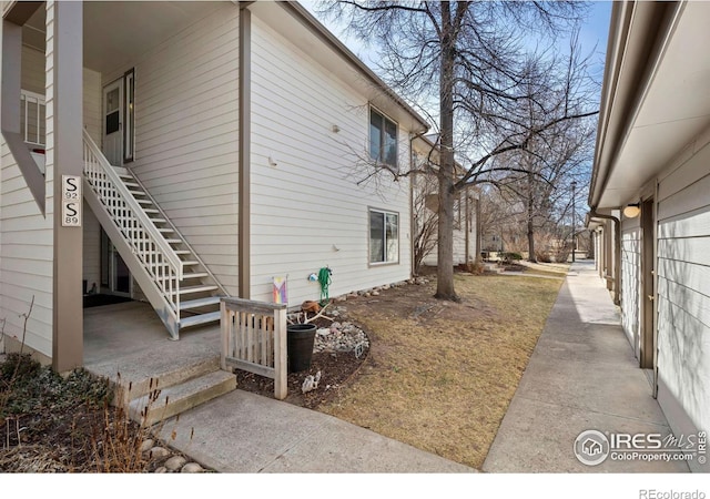 view of side of property featuring stairs