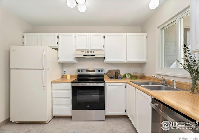 kitchen featuring under cabinet range hood, a sink, white cabinetry, appliances with stainless steel finishes, and light countertops