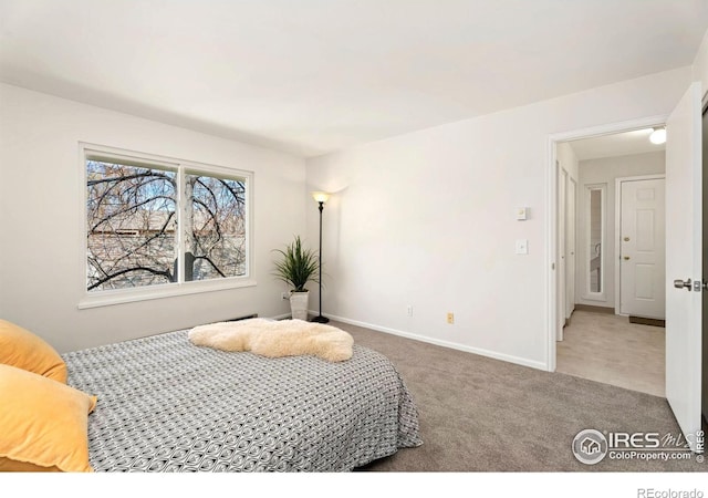 bedroom with carpet flooring and baseboards