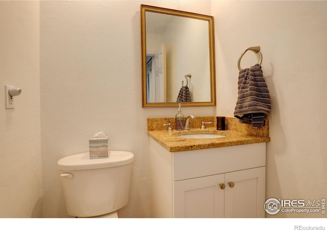 bathroom with toilet and vanity