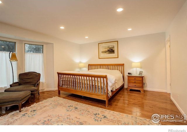 bedroom with recessed lighting, baseboards, and wood finished floors