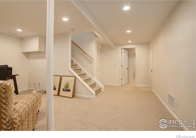 finished below grade area with visible vents, baseboards, stairway, carpet floors, and recessed lighting