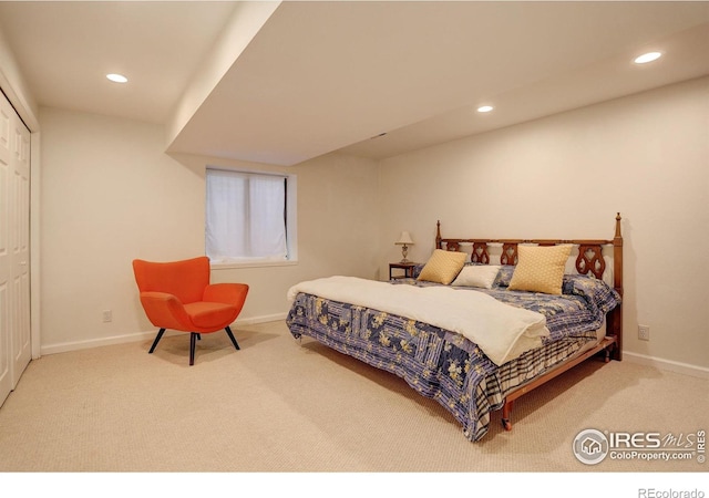 carpeted bedroom featuring a closet, recessed lighting, and baseboards