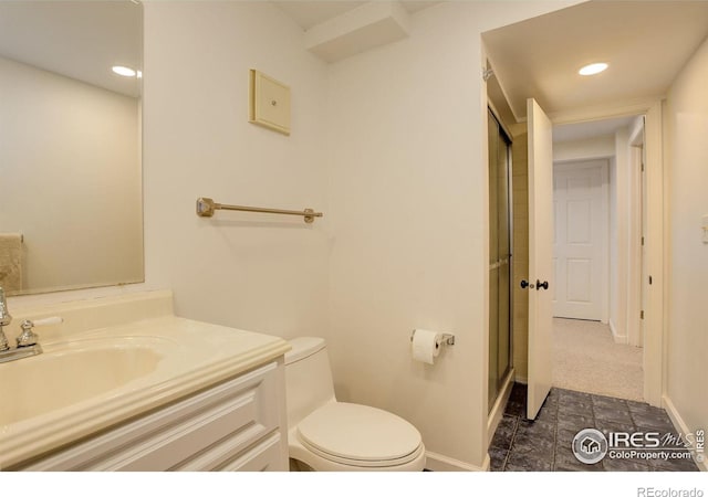 bathroom with an enclosed shower, toilet, vanity, and baseboards