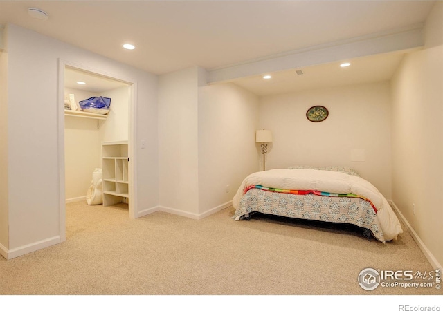 carpeted bedroom with recessed lighting, baseboards, and a spacious closet