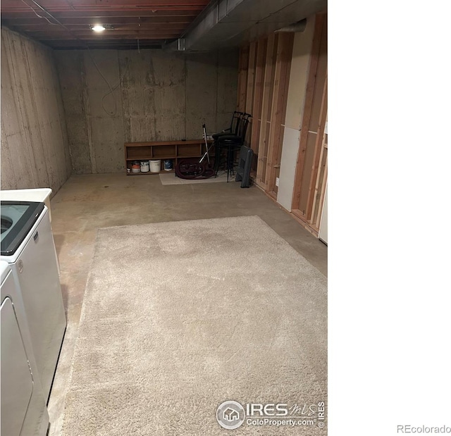 unfinished basement featuring washing machine and dryer