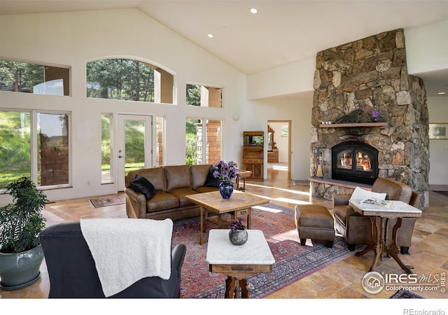 living room with high vaulted ceiling and a fireplace