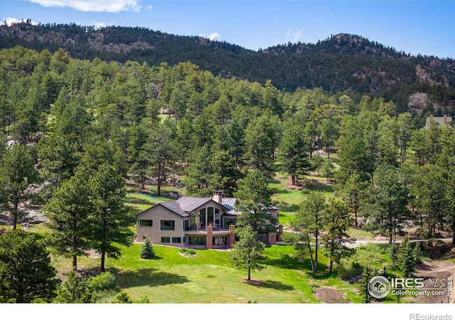 aerial view featuring a wooded view