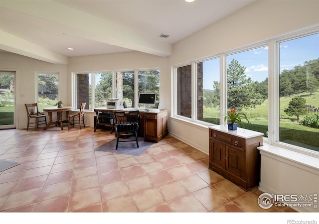 office space featuring light tile patterned flooring, visible vents, and baseboards