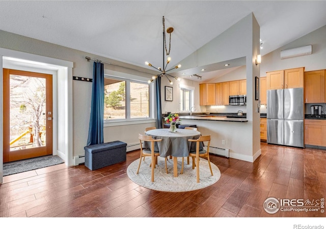 dining area featuring baseboard heating, an inviting chandelier, and wood finished floors