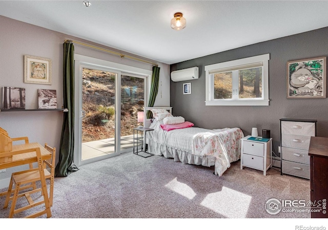 bedroom featuring carpet floors, access to outside, and a wall mounted AC