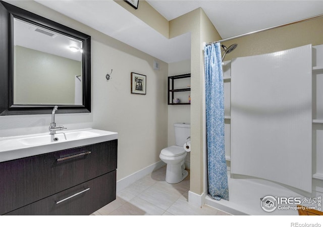 bathroom featuring visible vents, toilet, a stall shower, baseboards, and vanity