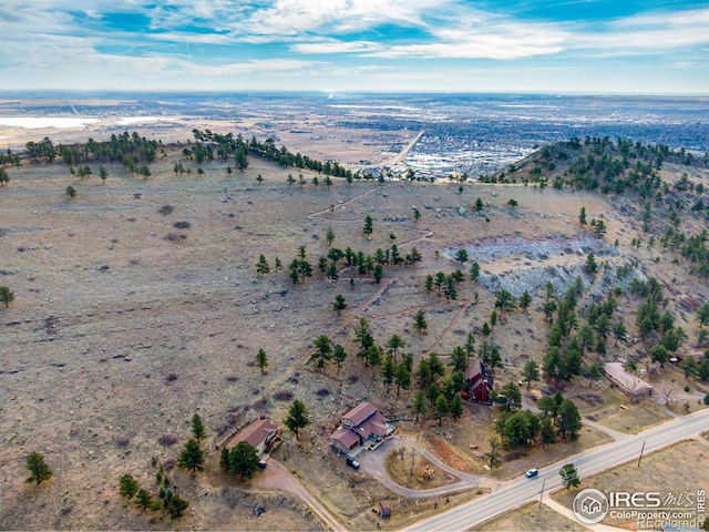 drone / aerial view featuring view of desert and a rural view