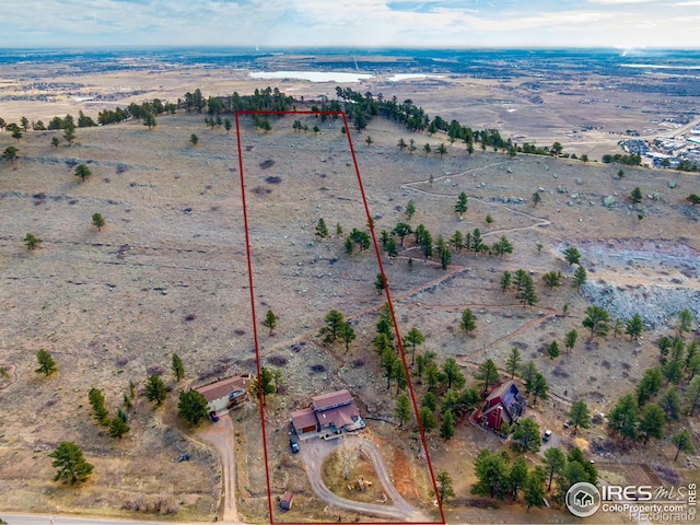 drone / aerial view featuring a rural view and view of desert