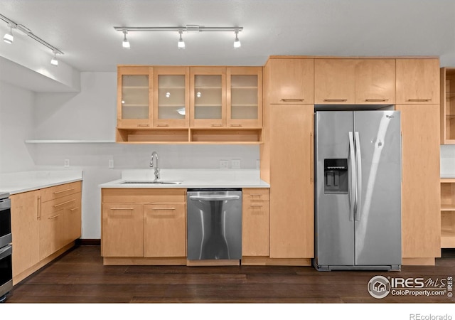 kitchen featuring light brown cabinets, open shelves, a sink, dark wood-type flooring, and appliances with stainless steel finishes