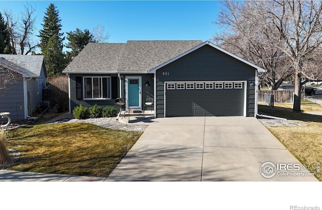 single story home with fence, concrete driveway, a front yard, a shingled roof, and an attached garage