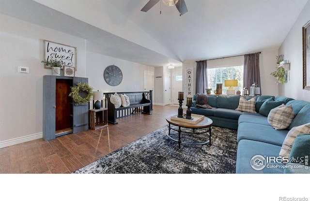 living room with baseboards, wood finished floors, a ceiling fan, and vaulted ceiling