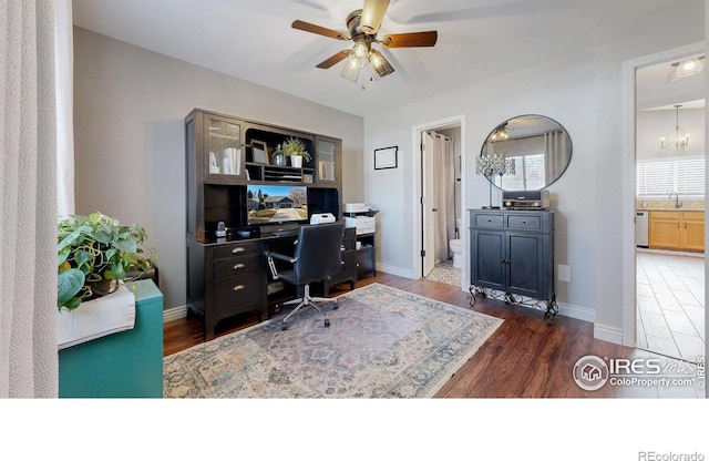 office area featuring wood finished floors, a ceiling fan, and baseboards