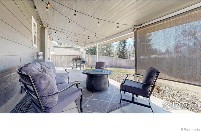 view of patio with fence and a fire pit