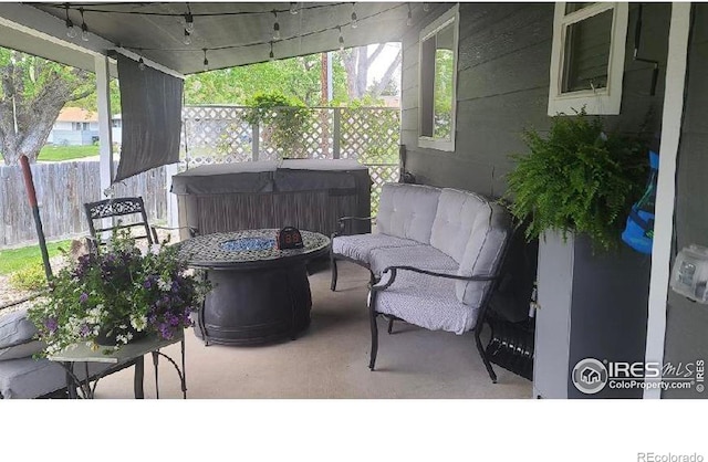 view of patio with a fire pit and fence